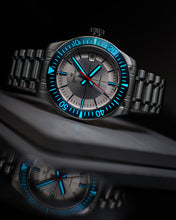 Load image into Gallery viewer, Swatch watch with blue accents on a reflective surface
